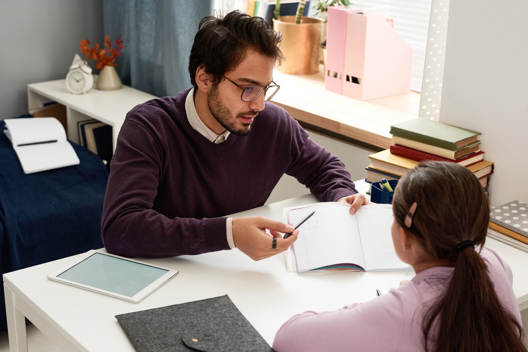 Tutor explaining new subject to girl